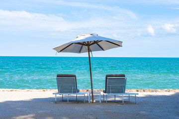 Beautiful umbrella and chair around beach sea ocean with blue sky for travel