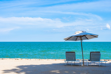 Beautiful umbrella and chair around beach sea ocean with blue sky for travel