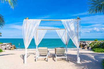 Fototapeta na wymiar Beautiful umbrella and chair around beach sea ocean with blue sky for travel