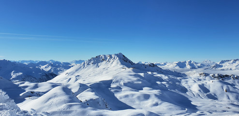 Fototapeta na wymiar beautiful view alpine french snowy peak mountain under blue sky