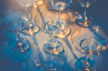 Row of wineglasses on table in nightclub bar and pub restaurant. Glassware and drinking beverage...
