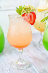A variety of soft drinks. Assortment of soft drinks. Tarragon lemonade, Strawberry lemonade, Pear lemonade. Lemonade on a light background.