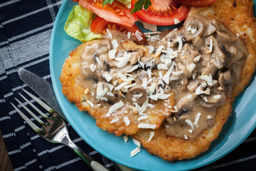 Crispy fried homemade potato pancakes with mushroom sauce.