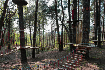 A bridge of logs tied to ropes, part of the rope route. Extreme sport.