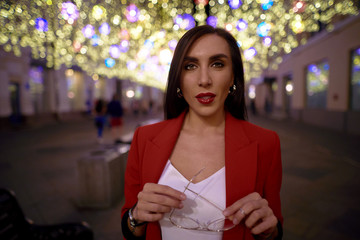 Woman on a background of the night city. Look amazing in red lipstick             