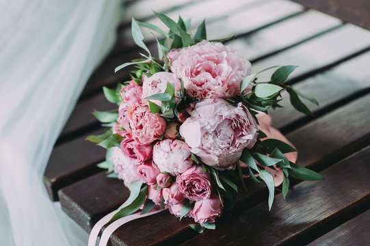 beautiful wedding bouquet of different flowers on a wood background