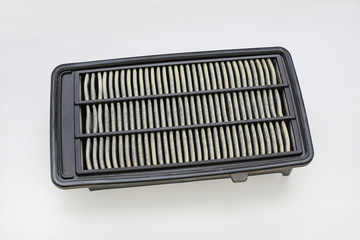 Dirty used car air conditioner filter on white background.