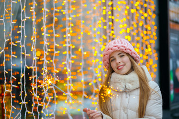 Pleased girl holding bengal lights