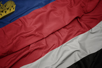 waving colorful flag of yemen and national flag of liechtenstein.
