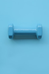 close up of dumbbell on blue background