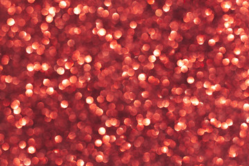 Abstract red background. Shiny glitter bokeh in red colors.