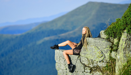 Hiking peaceful moment. Enjoy the view. Tourist hiker girl relaxing edge cliff. Dangerous relax. Extreme concept. On edge of world. Woman sit on edge of cliff in high mountains landscape background