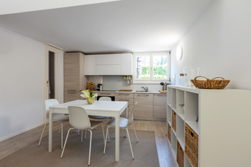 Fototapeta premium Very nice kitchen with design table and chairs