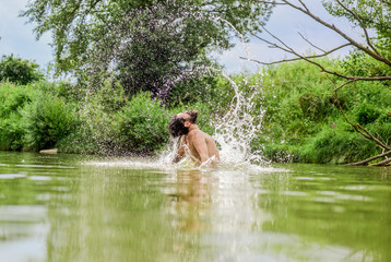 Fototapeta na wymiar leisure time. bearded man swimming in lake. summer vacation. mature swimmer. brutal hipster with wet beard. refreshing in river water. water beast. furry monster. wild man. time to relax