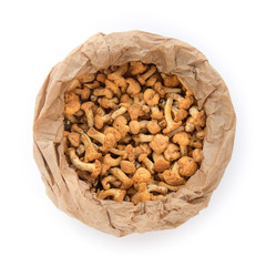 top view of cantharellus, mushrooms in a paper bag on white background (the food has just been picked in the woods)