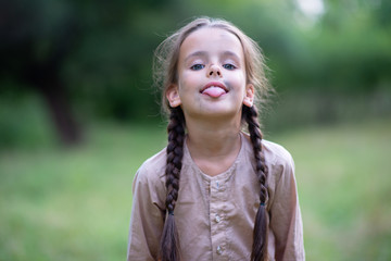 Pretty little girl with long brown hair and beautiful dirty face posing summer nature outdoor....