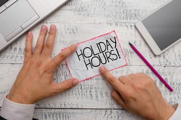 Conceptual hand writing showing Holiday Hours. Concept meaning Overtime work on for employees under...