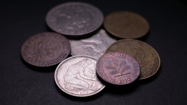 Close Up Of Old German Coins Rotating On Black Background. Loop Video