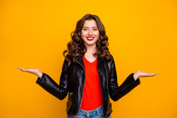 Photo of pretty lady promoter holding on arms two best products for picking wear leather jacket isolated yellow background