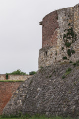 Fragment of the fortress wall, tower with stony stone loopholes