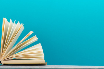 Open book, hardback books on wooden table. Back to school. Copy space