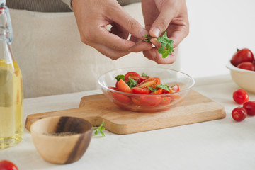 Fresh delicious salad with tomatoes. Doing fresh green salad