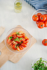 Fresh salad with tomato, mozzarella and basil. Concept for a tasty and healthy appetizer