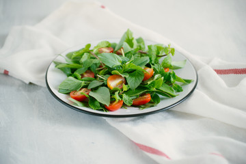 Fresh delicious salad with tomatoes. Doing fresh green salad