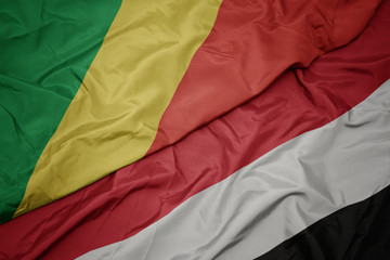 waving colorful flag of yemen and national flag of republic of the congo.