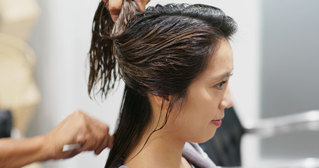 Woman having hair treatment in beauty salon