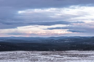 View of the snowy hills in severe nature of northern Finland