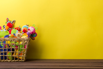 Toys collection in box on abstract wooden background. Donatation. Copy space for text