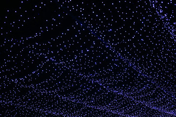 Abstract blue bokeh from lighting decor for background. Night festive lighting of city street