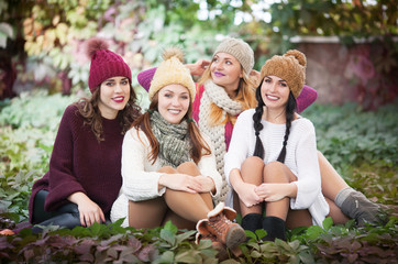 Fototapeta premium Portrait of best friends in autumn clothes on the park in autumn.