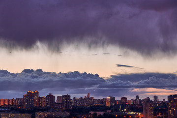 Obraz premium Background.Dark gloomy ragged clouds over the evening city.