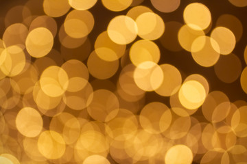Abstract beautiful blurred gold yellow colored bokeh from ornamental lights flickering in the park....