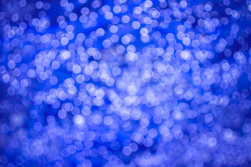 Abstract beautiful blurred brightness purple colored bokeh from electric blue ornamental lights flickering in the park. Background for celebrate party, merry Xmas, happy new year concept.
