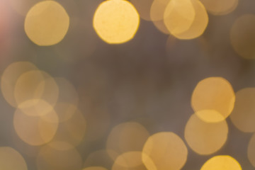 Abstract beautiful blurred gold yellow colored bokeh from ornamental lights flickering in the park...