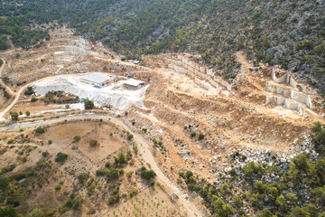 Marble quarry ledges. Terraces of cutted stone material. Aerial view.