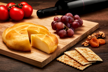 Turkish smoked abaza cheese on wooden table with wooden cutting board