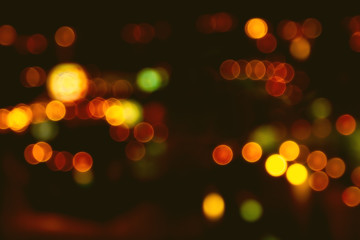 Abstract beautiful blurred colorful bokeh from ornamental lights flickering on the road with haze filter. Background for nightlife people or street night traveler concept. Bangkok Thailand.