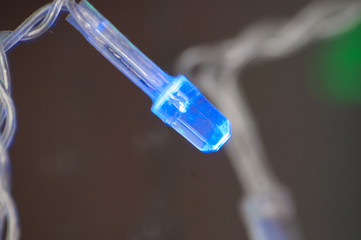 Blue light bulb Christmas garland close-up macro