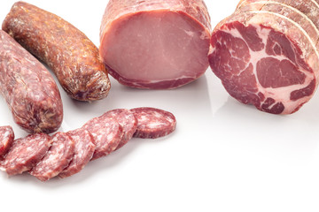 Salami sausages sliced  on white table.