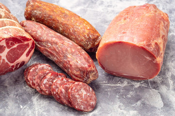 Variety of meat products including ham and sausages.
