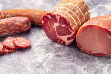 Variety of meat products including ham and sausages.