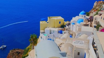 Santorini Oia. Beautiful view of white typical village and Aegean Sea i. View of blue domed churches -famous tourist attraction in Greece.
