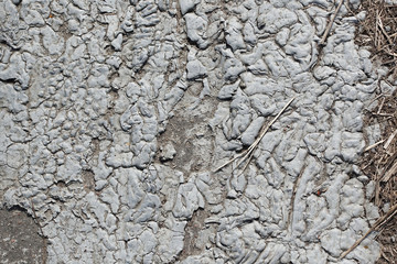 Abstract background. Dried gray paint dried with relief patterns