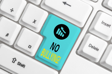 Word writing text No Bullying. Business photo showcasing stop aggressive behavior among children power imbalance White pc keyboard with empty note paper above white background key copy space