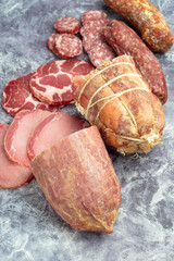 Display of a variety of seasoned ham and smoked sausages