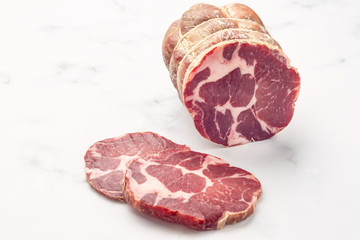 Close up of italian pancetta bacon on white stone